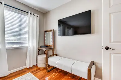 a room with a tv on the wall and a window at 1 Mi to Shopping and Dining Central Burbank Duplex in Burbank