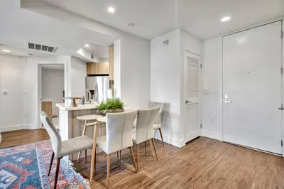 a kitchen and dining room with a table and chairs at 13 Luxury apartment in Los Angeles