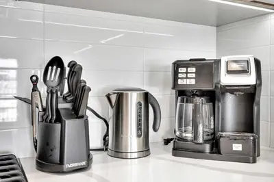 a kitchen counter with a coffee maker and utensils at 13 Luxury apartment in Los Angeles