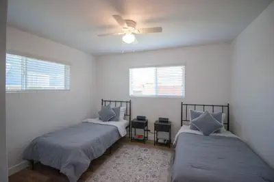 a bedroom with two beds and a ceiling fan at Comfortable & Modern 3BD/2BA Home -pet friendly! in Lawndale