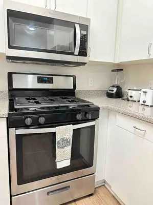 a microwave above a stove in a kitchen at Luxe MDR apartment,Parking, Gym, Pool, jacuzzi,BBQ in Los Angeles