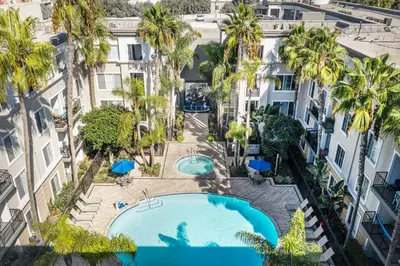 an overhead view of a pool in a building with palm trees at Luxe MDR apartment,Parking, Gym, Pool, jacuzzi,BBQ in Los Angeles