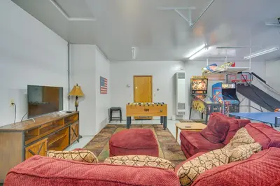 a living room with a couch and a table at Big Bear Lake Cabin with Hot Tub and Gas Fire Pit! in Big Bear Lake