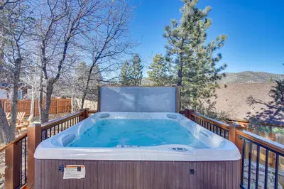 a jacuzzi tub on a deck at Big Bear Lake Cabin with Hot Tub and Gas Fire Pit! in Big Bear Lake