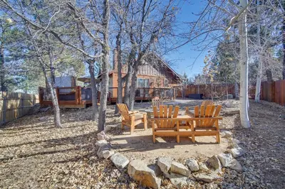 a picnic table and chairs in front of a house at Big Bear Lake Cabin with Hot Tub and Gas Fire Pit! in Big Bear Lake