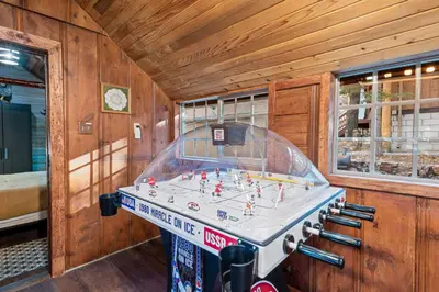 a room with a foosball game on a table at Warbler's Roost - Perfect vintage cabin in the woods in Big Bear Lake