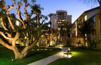 a park with a bench and a tree and a building at Nautical 2 Bedroom with Beautiful Ocean Views in Los Angeles