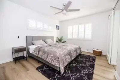 a bedroom with a bed and a ceiling fan at Private Pool Retreat Near Disney Game Room & Firepit in Fullerton
