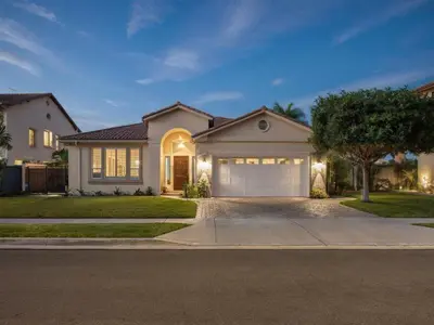 a large white house with a garage at Spacious Disney Retreat with Pool Table Fire Pit in Placentia