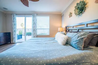 a bedroom with a large bed with a large window at Spacious Disney Retreat with Pool Table Fire Pit in Placentia