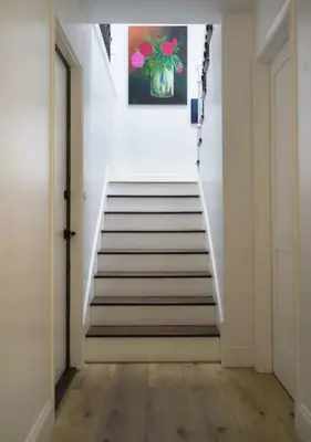 a hallway with stairs with a painting on the wall at SeaView, Pool, HotTub, W/D, Bikes, Gated Community in Port Hueneme