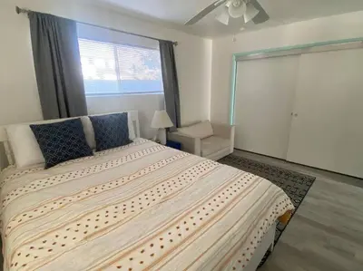 a bedroom with a large bed and a window at Sea View, Boards, Bikes, W/d in Oxnard