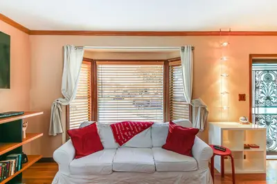a living room with a white couch with red pillows at Gardena Vacation Rental 5 Mi to Manhattan Beach! in Gardena
