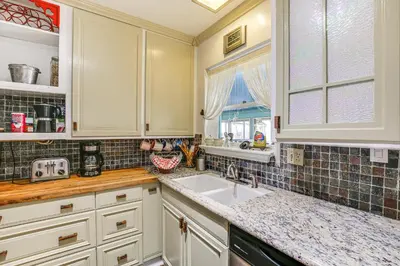 a kitchen with white cabinets and a sink and a window at Gardena Vacation Rental 5 Mi to Manhattan Beach! in Gardena