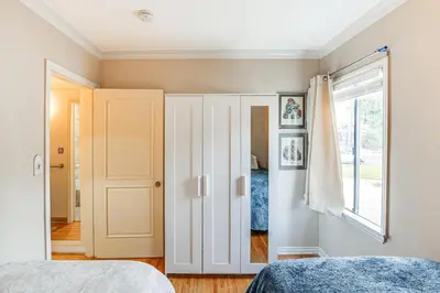 a bedroom with a white closet and a window at Gardena Vacation Rental 5 Mi to Manhattan Beach! in Gardena