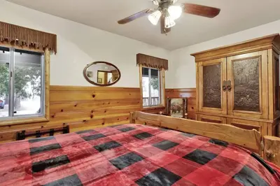 a bedroom with a bed and a ceiling fan at Timber Pines Chalet~ Hot Tub~ Walk to Lake/Marina~ in Big Bear Lake