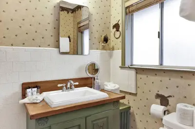 a bathroom with a sink and a mirror at Timber Pines Chalet~ Hot Tub~ Walk to Lake/Marina~ in Big Bear Lake