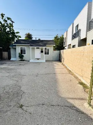 a house with a driveway in front of a building at Walk To Americana on Brand. in Glendale