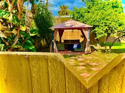 a gazebo in a yard behind a fence at Walk To Americana on Brand. in Glendale