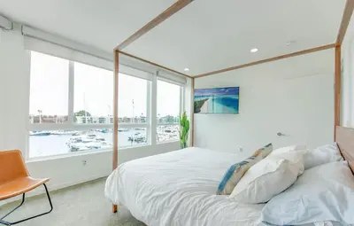 a bedroom with a large bed and a large window at Wake Up to Spectacular Marina Views in this 2 Bedroom Condo in Los Angeles