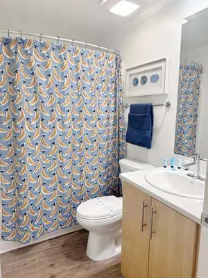 a bathroom with a toilet and a shower curtain at Wake Up to Spectacular Marina Views in this 2 Bedroom Condo in Los Angeles