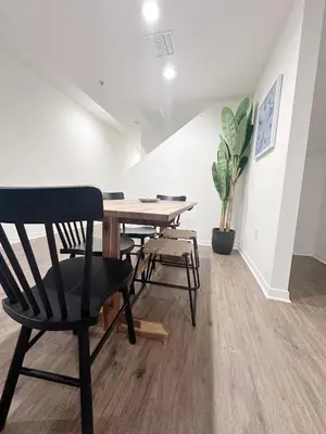a dining room with a wooden table and chairs at Wake Up to Spectacular Marina Views in this 2 Bedroom Condo in Los Angeles