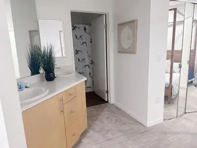 a bathroom with a sink and a mirror at Wake Up to Spectacular Marina Views in this 2 Bedroom Condo in Los Angeles
