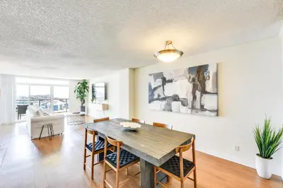 a dining room with a wooden table and chairs at Marina Life: Smell the Sea, Feel the Breeze in Los Angeles