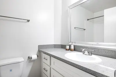 a white bathroom with a sink and a mirror at Westwood 1BR w Gym Pool Spa nr UCLA LAX-265 in Los Angeles