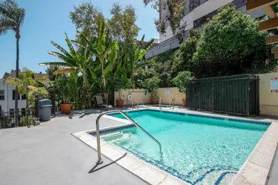 a swimming pool in an apartment complex with trees at Westwood 1BR w Gym Pool Spa nr UCLA LAX-265 in Los Angeles