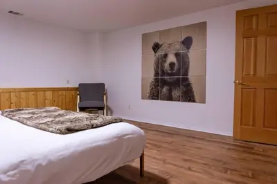 a bedroom with a bed and a picture of a bear at Apres-Ski Chalet Mt High Wrightwood Ski Resort in Wrightwood