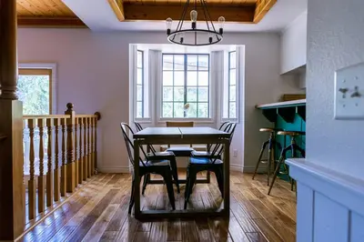 a dining room table with chairs and a chandelier at Apres-Ski Chalet Mt High Wrightwood Ski Resort in Wrightwood