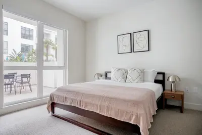 a white bedroom with a bed and a large window at Inglewood 1br w sundeck clubhouse nr shopping LAX-1160 in Inglewood