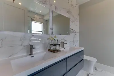 a white bathroom with a sink and a mirror at Luxury Modern 4 Bedroom 4 Bathroom Home with Rooftop Deck #4 in Los Angeles