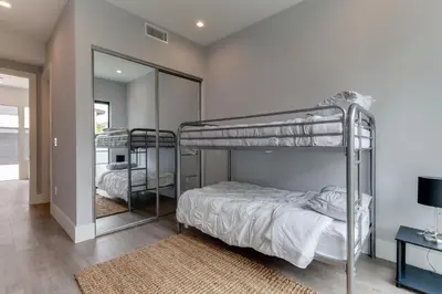 a bedroom with two bunk beds and a mirror at Luxury Modern 4 Bedroom 4 Bathroom Home with Rooftop Deck #4 in Los Angeles