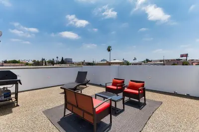 a group of chairs and a table on a roof at Luxury Modern 4 Bedroom 4 Bathroom Home with Rooftop Deck #4 in Los Angeles