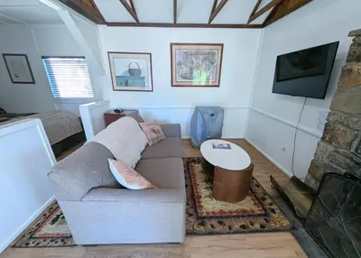 a living room with a couch and a table at Fox n Bear Cottages Big Bear in Big Bear Lake