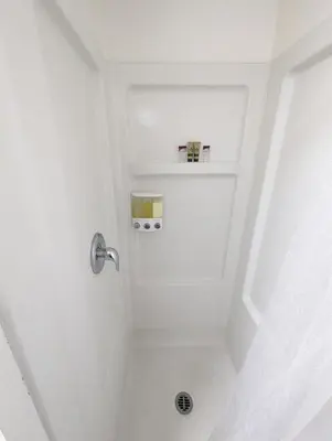 a bathroom with a shower with a white ceiling at Fox n Bear Cottages Big Bear in Big Bear Lake