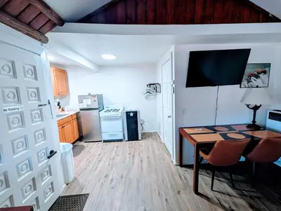 a kitchen with a desk and a table in a room at Fox n Bear Cottages Big Bear in Big Bear Lake