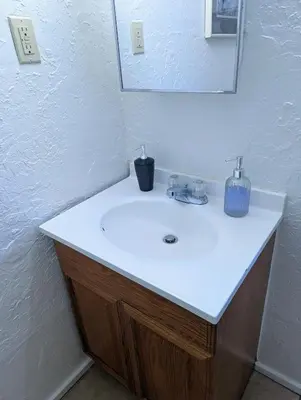 a bathroom with a white sink and a mirror at Fox n Bear Cottages Big Bear in Big Bear Lake