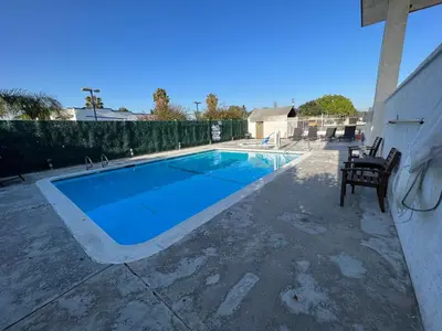 a swimming pool in the middle of a patio at The Dixie Orange County in Stanton