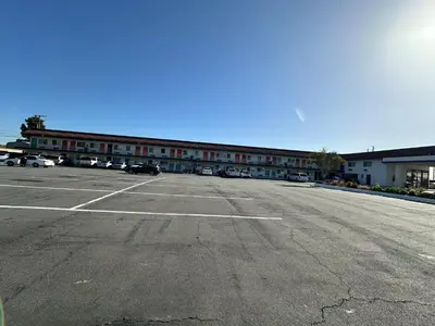 an empty parking lot in front of a building at The Dixie Orange County in Stanton