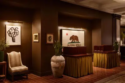 a lobby with a bear picture on the wall and a vase at Pasadena Hotel & Pool in Pasadena