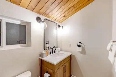 a bathroom with a sink and a mirror at Pinecrest Paradise in Crestline