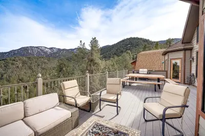 a patio with chairs and a table on a deck at Pine Mountain Club Cabin with Private Deck and Views! in Pine Mountain Club