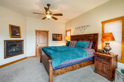 a bedroom with a bed and a ceiling fan at Pine Mountain Club Cabin with Private Deck and Views! in Pine Mountain Club