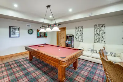 a living room with a pool table and a couch at Pine Mountain Club Cabin with Private Deck and Views! in Pine Mountain Club