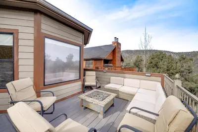 a deck with chairs and a coffee table on a house at Pine Mountain Club Cabin with Private Deck and Views! in Pine Mountain Club
