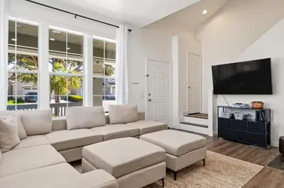 a living room with a couch and a flat screen tv at Olivia Oasis in Oxnard