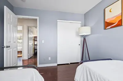a bedroom with blue walls and two beds at Olivia Oasis in Oxnard